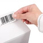hand sticking a barcode sticker